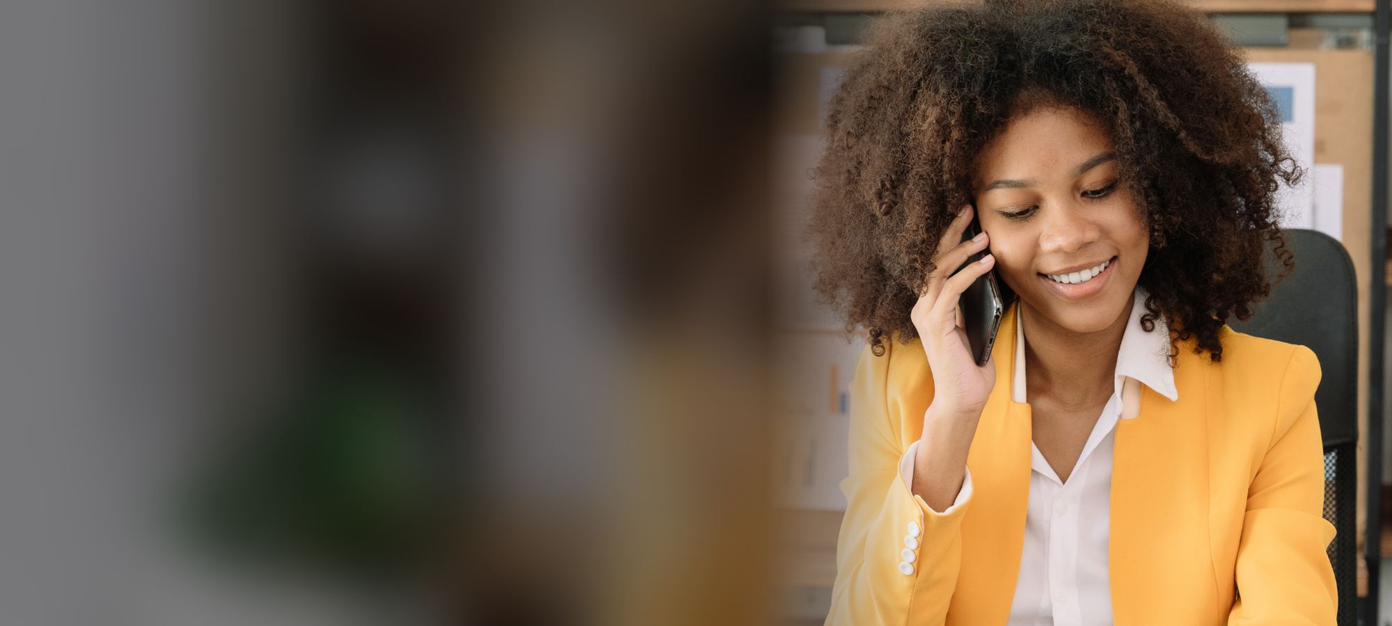 Smiling woman discussing a software renewal on the phone